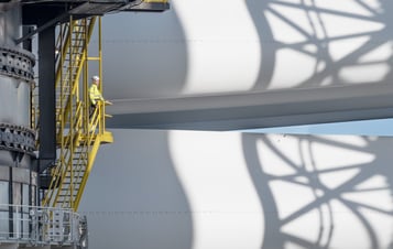 A worker looking at wind turbine components at Hollandse Kust Zuid A worker looking at wind turbine components at Hollandse Kust Zuid
